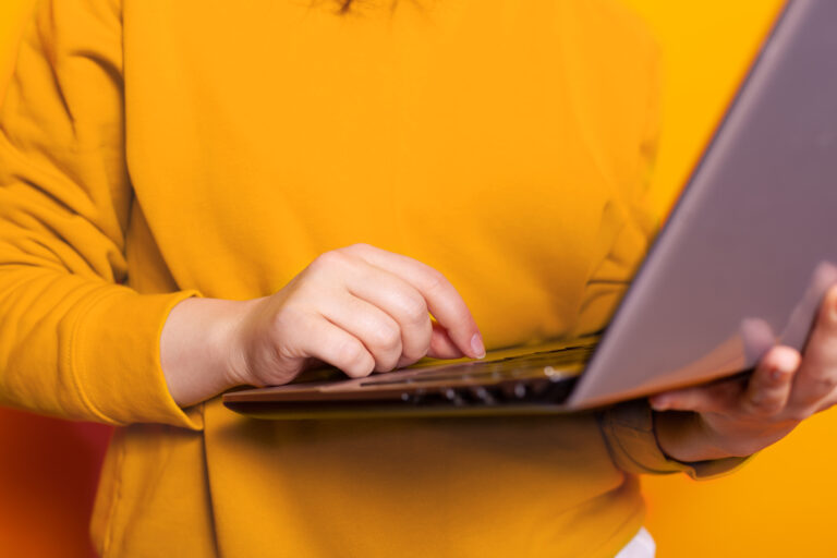 close up of hand of person using modern laptop