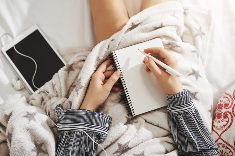 Person journaling at night representing a simple productive night routine before bed